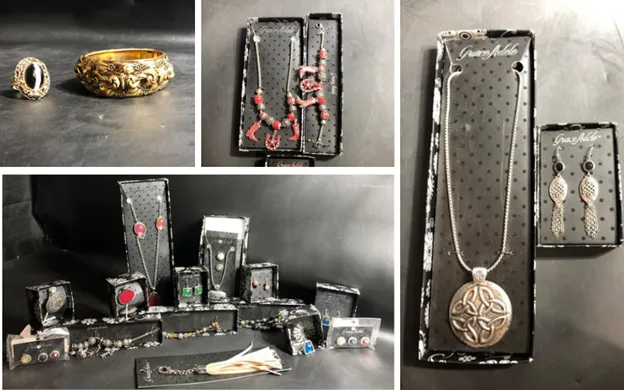 A vintage jewelry box filled with custom pieces and assorted items, showcasing unique estate sale treasures.