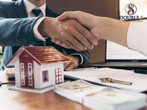 Handshake over a model home and cash, representing estate services and property sales by Double S Auctions Amarillo
