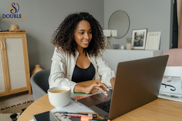 Person browsing online auction listings on a laptop with coffee nearby.