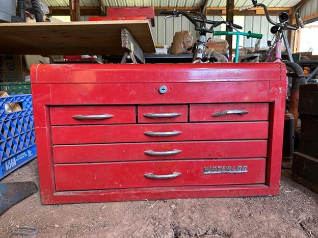 Red Waterloo tool chest being valued by professional auctioneers for better estate returns.